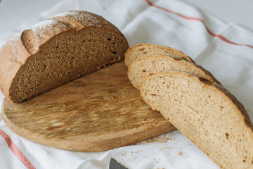 Sliced bread and ears on white tablecloth