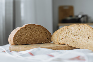 Sliced bread and ears on white tablecloth