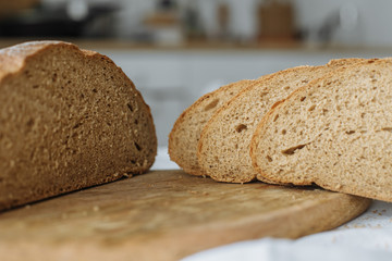 Sliced bread and ears on white tablecloth