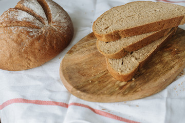 Sliced bread and ears on white tablecloth