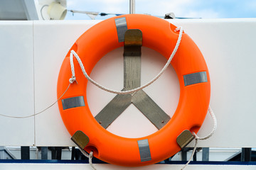 orange lifebelt buoyancy aid with rope