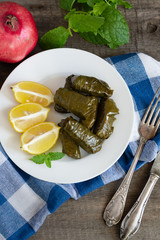 Grape leaf filled with rice served with lemon. Traditional Greek food