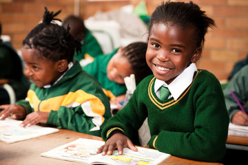 A young girl sitting at a desk in a classroom, Meyerton Primary School, Meyerton, Gauteng