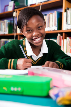 A young girl in school uniform sitting at a desk, Meyerton Primary School, Meyerton, Gauteng