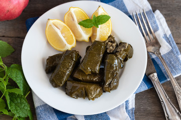 Grape leaf filled with rice served with lemon. Traditional Greek food