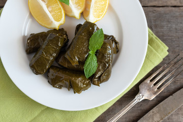 Grape leaf filled with rice served with lemon. Traditional Greek food