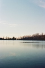 Sunset over lake in wild burn area