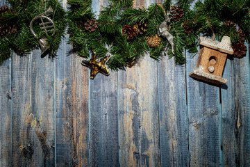Merry christmas and new year concept. Christmas wooden blue background with Christmas toys birdhouse, bugle and star