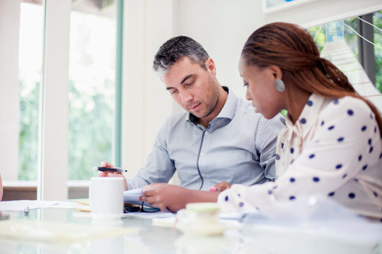 Two colleagues looking at a document at a meeting