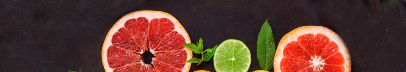 banner of citrus food pattern on white background - assorted citrus fruits with mint leaves on black background