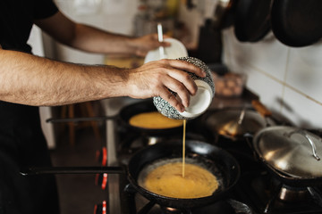Professional chef working in restaurant kitchen and making delicious traditional food.