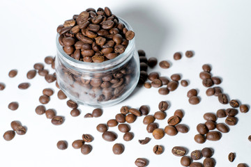 Coffee beans in a jar on a white background.