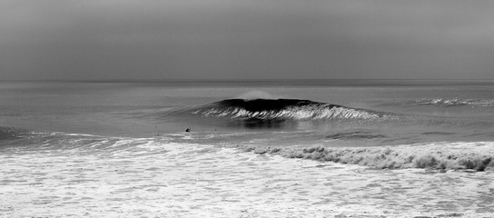 surf kayak in big waves black and white