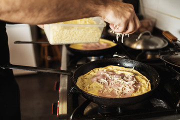 Professional chef working in restaurant kitchen and making delicious traditional food.