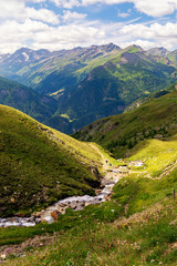 Fototapeta na wymiar Mountain river and picturesque slopes of the Austrian Alps