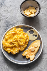 Kids funny breakfast with scrambled eggs, cheese and tortilla space rocket