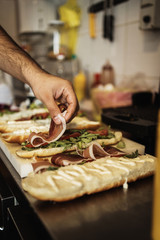 Professional chef working in restaurant kitchen and making delicious traditional food.