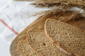 Sliced bread on a board on a white tablecloth