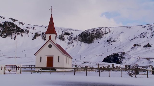 Low angle, church and graveyard in winter Iceland landscape