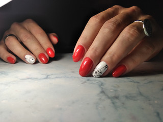 Beautiful manicure with red coating and white design. Long round nails with dandelion design on...