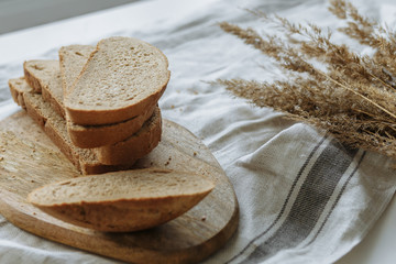 Sliced bread on a board on a white tablecloth