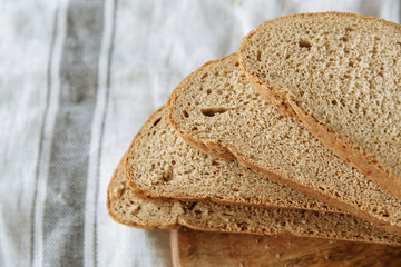 Sliced bread on a board on a white tablecloth