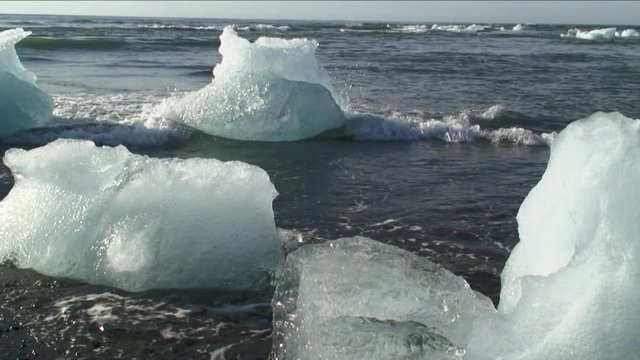 Pan right, chunks of glacial ice on Iceland beach