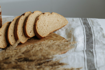 Sliced bread on a board on a white tablecloth