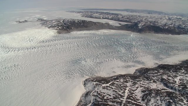 Flying over large glacier, helicopter point of view