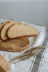 Sliced bread on a board on a white tablecloth