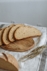 Sliced bread on a board on a white tablecloth