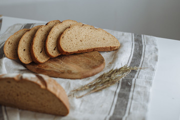 Sliced bread on a board on a white tablecloth