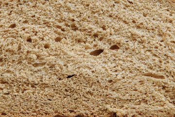 Sliced bread on a board on a white tablecloth