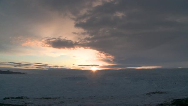 Sunset timelapse over frozen tundra, wide
