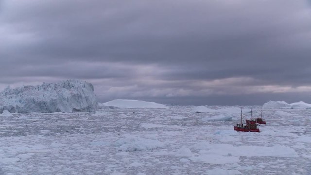 Wide, boat traverses sea ice in Greenland