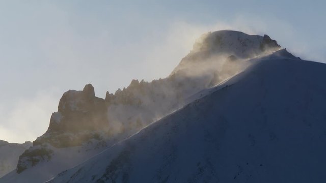 Sun shines over snowy mountains in Iceland, wide