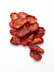 Sun Dried tomatoes in the sunshine on white