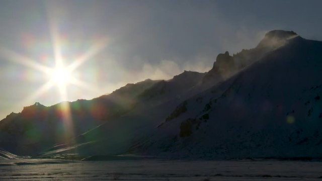 Wide, sun shines over tundra mountains in Iceland