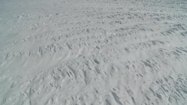Helicopter flies over polar glacier, point of view