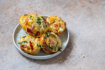 Delicious egg muffins with ham, cheese, spinach and vegetables