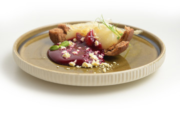 Pear dessert with milk sauce on a plate