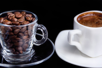 Aromatic morning coffee in a white cup, coffee grains