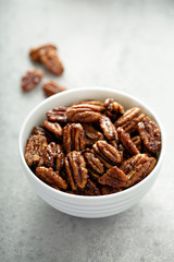 Caramelized or candied pecans for appetizer or salad in white bowl