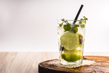 mojito, Cuban drink known worldwide. Fresh Mojito in glasses on wooden table.