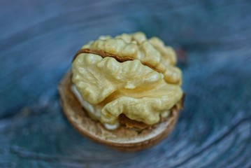 yellow fresh walnut lies on a gray table