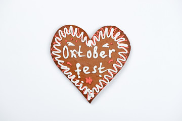 The gingerbread heart with Oktoberfest inscription on white background