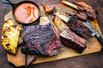 Barbecue smoked sliced hot marinade chuck beef ribs with pineapple and spicy chili sauce as top...