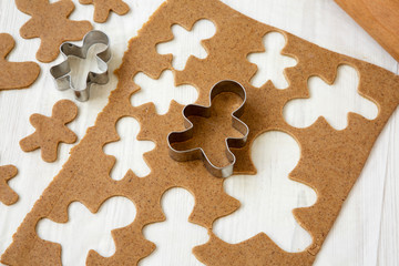 Homemade raw dough for making Christmas cookies on a white wooden background, low angle view.