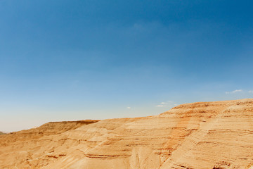 Jordan: landscape with mountains, with red yellow ground and blue sky.