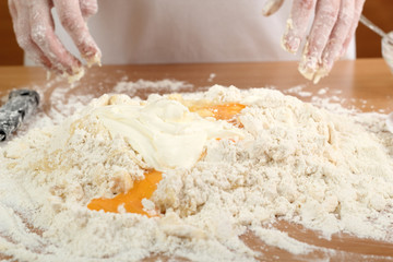A baker mixing flour, sour cream and eggs. Making Pastry Dough for Hungarian Cake. Series.
